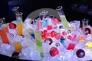closeup of ice bucket with shot and fruit juice test tubes and cocktail ÃÂ  photo